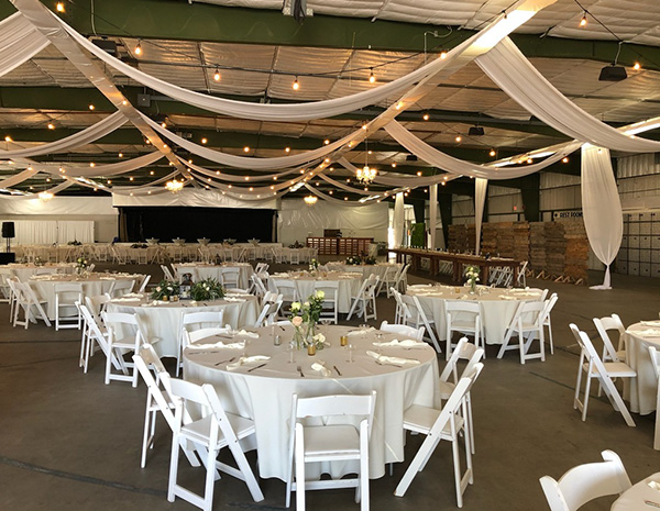 The theater building full of white tables and chairs for a formal event